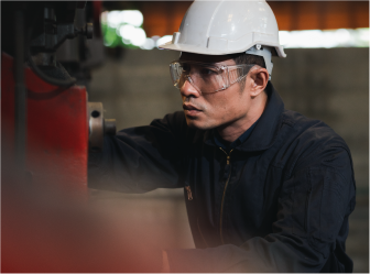 worker operating machinery, symbolizing manufacturing success from web development and digital marketing services