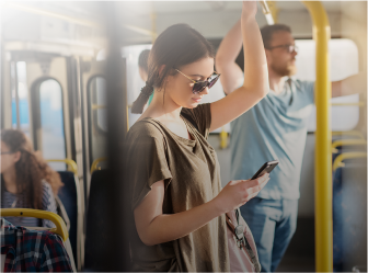 person checking their phone on public transport, reflecting convenience through successful web development for transportation